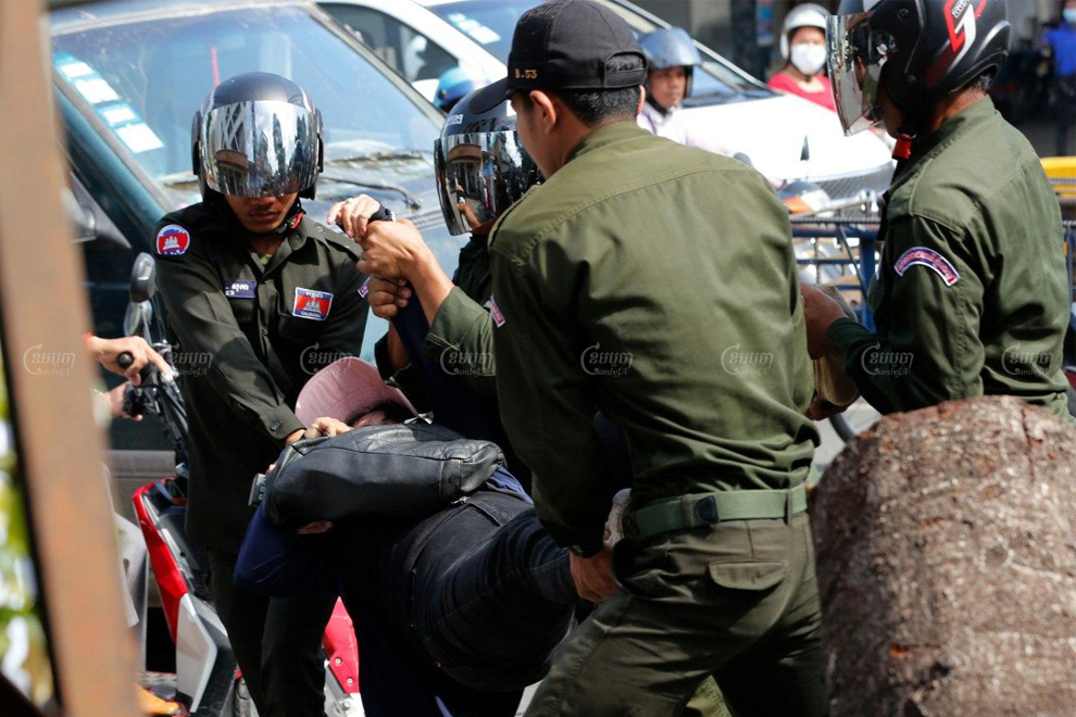 District security guards carry a protester away from a demonstration marking Paris Peace Agreements Day outside the Chinese Embassy in Phnom Penh on October 23. Panha Chhorpoan