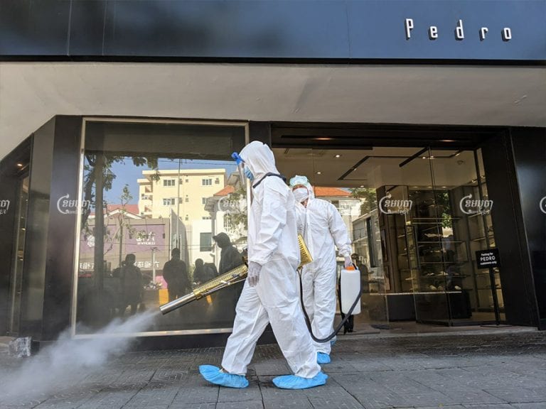 Health workers disinfect a fashion store in Phnom Penh where at least seven staff members have tested positive for COVID-19 since November 28. Panha Chhorpoan