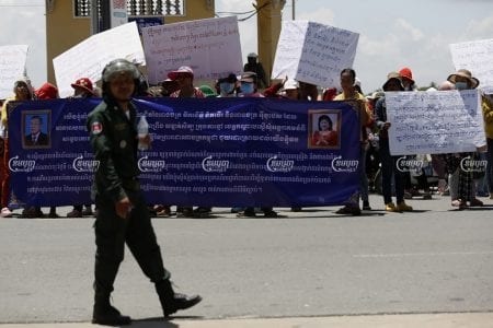 About 200 workers who were marching to the Kandal Provincial Court in Takhmao City on July 13 to submit a petition asking that the court remove an injunction preventing them from being paid by their former factory owner. Panha Chhorpoan