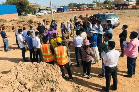 People affected by construction of a roadside weigh station in Kampong Chhnang province speak with authorities after blocking contractors sent to demarcate the site on January 8. Supplied