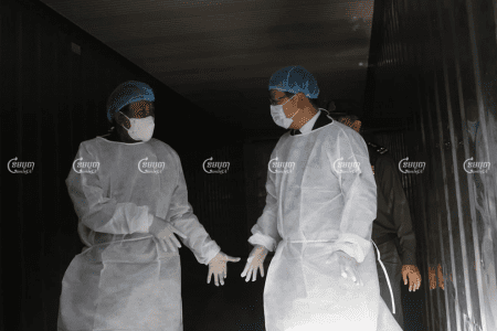 Defense Minster Tea Banh and Chinese Ambassador Wang Wentian are dressed in PPE during a visit to Preah Ket Melea Hospital in Phnom Penh on Wednesday. Panha Chhorpoan