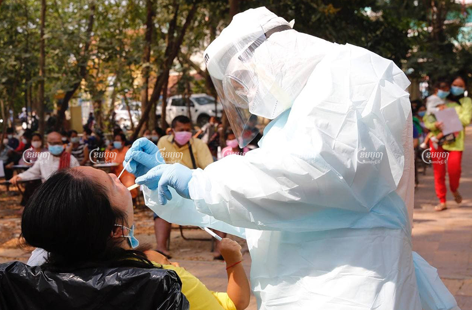 Medical officials take samples from the mother of a student at Hun Sen Phnom Penh Thmey High School on Monday following the new community outbreak of Covid-19. Panha Chhorpoan
