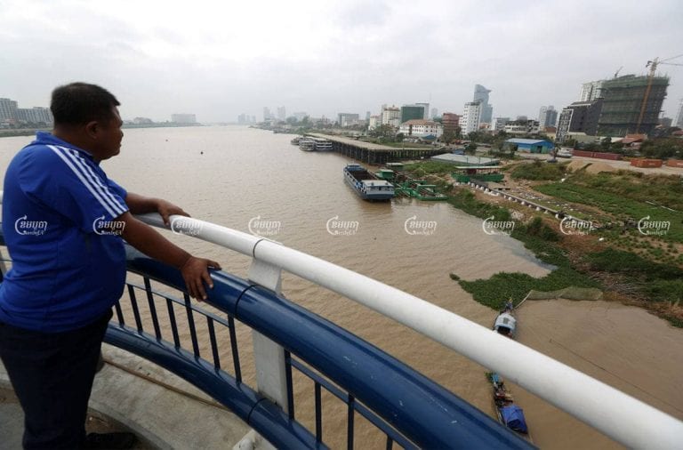 A man looks from the Chroy Changvar bridge at the site of Yuetai Group's City Gate development in Phnom Penh, on February 24, 2021. CamboJA/ Pring Samrang