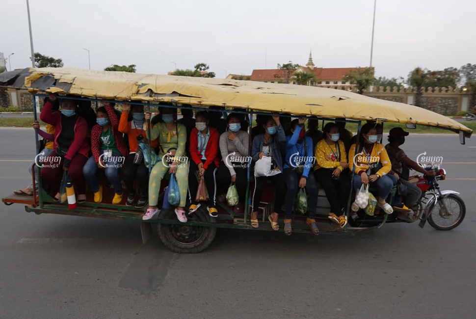 Garment workers travel home from work at a factory on the outskirts of Phnom Penh, March 2, 2021. Panha Chhorpoan