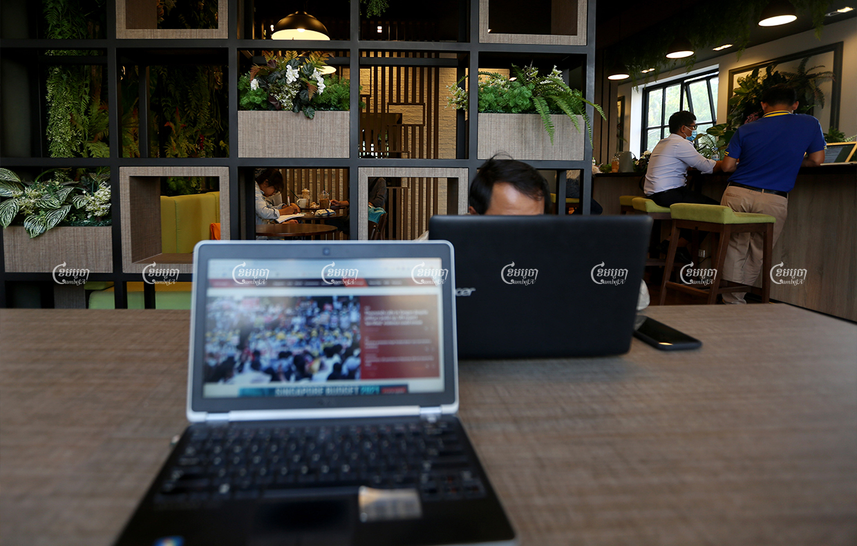 People use free wi-fi at a coffee shop in Phnom Penh, February 2021. CamboJA/ Pring Samrang