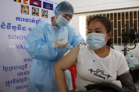 A garment worker is vaccinated against COVID-19 at a factory in Phnom Penh, on the first day of a campaign to vaccinate garment workers, April 7, 2021. CamboJA/ Panha Chhorpoan