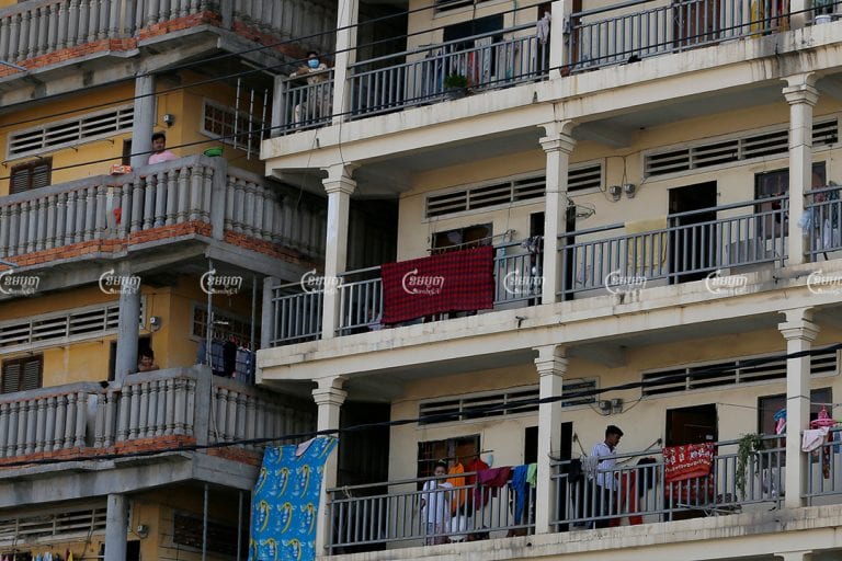 Garment workers stand in front of their rented apartments in the Stung Meanchey III commune of Meanchey district, one of the strictly patrolled COVID-19 red zones in Phnom Penh, April 22, 2021. CamboJA/ Panha Chhorpoan