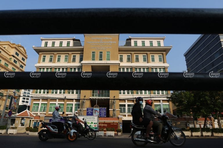 Motorists drive past the Phnom Penh Municipal Court, March 31, 2021. CamboJA/ Pring Samrang