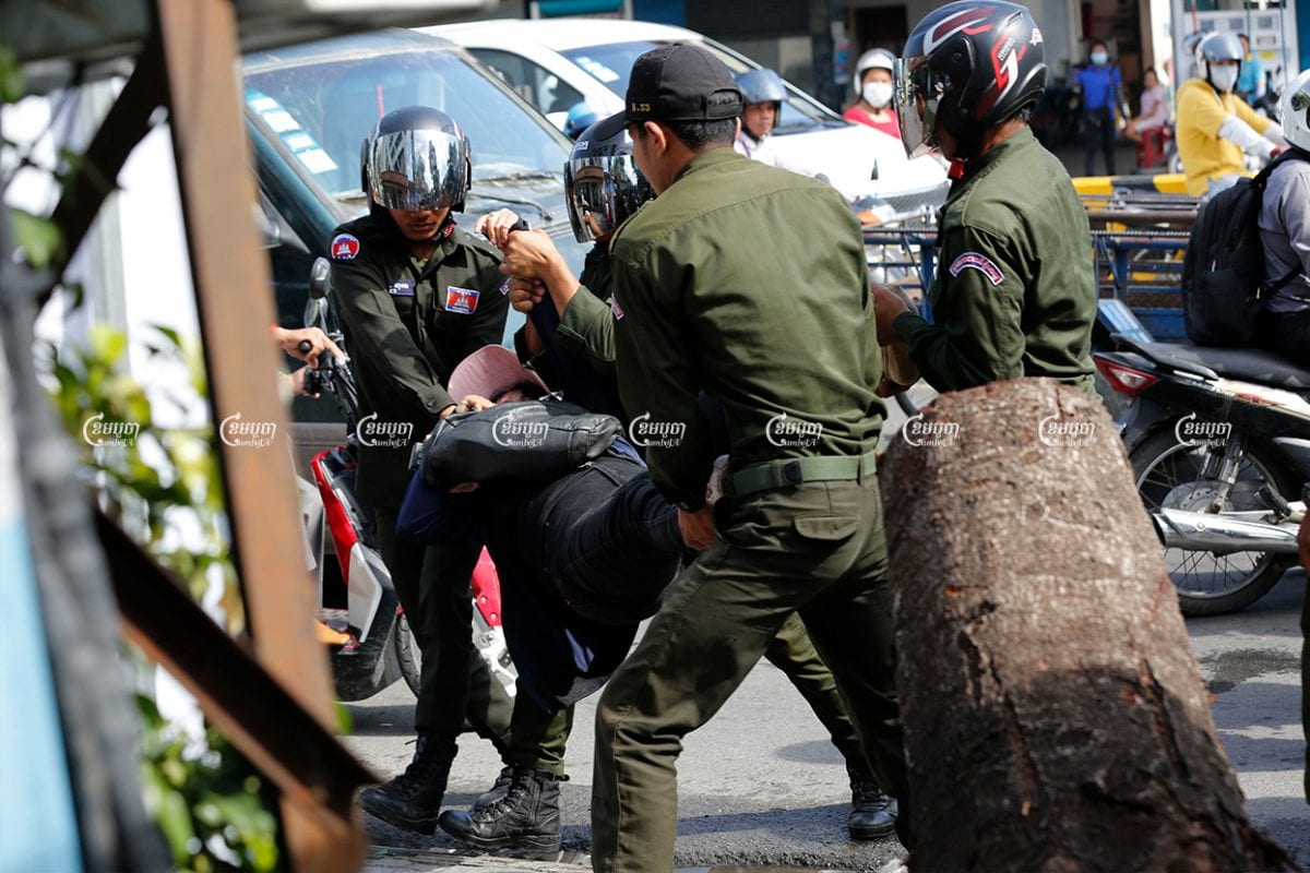 District security guards carry a protester away from a demonstration marking the Paris Peace Agreements Day outside the Chinese Embassy in Phnom Penh on October 23. CamboJA/ Panha Chhorpoan