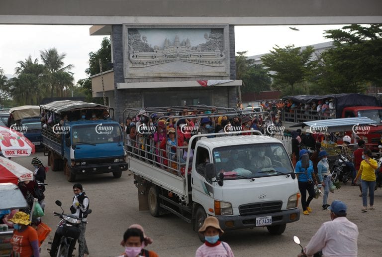 Garment workers ride on a crowded truck after finishing their shift at a factory in the Kong Pisei district of Kampong Speu province on May 6, 2021. CamboJA/ Panha Chhorpoan