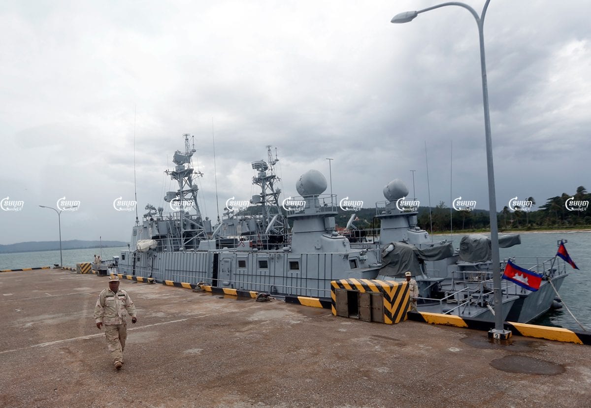 A naval officer walks near patrol boats at Ream Naval Base in Sihanoukville, Cambodia. Picture taken during a media trip organized by the government on July 26, 2019. CamboJA/ Pring Samrang