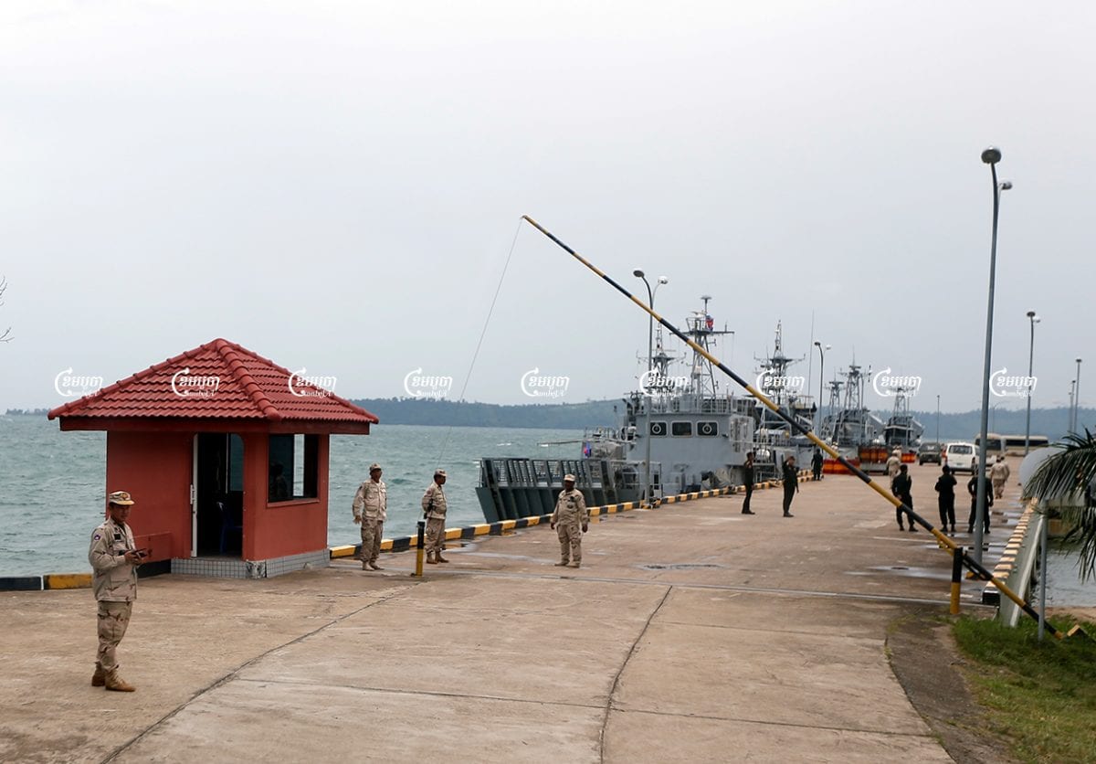 Naval officers stand guard near patrol boats at Ream Naval Base in Sihanoukville, Cambodia. Picture taken during a media trip organised by the government on July 26, 2019. CamboJA/ Pring Samrang