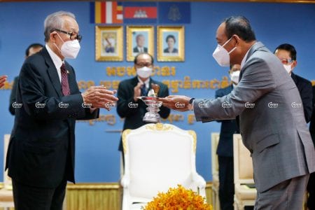 Prach Chan (R), the new chairman of the National Election Committee, receives the NEC seal from Minister of the Royal Palace Kong Sam Ol at a ceremony in Phnom Penh, June 30, 2021.CamboJA/ Panha Chhorpoan