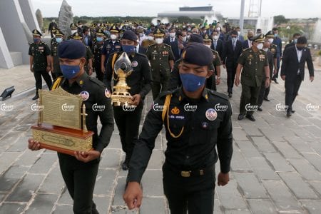 Soldiers carry Cambodia's first drop of crude oil during a ceremony at Phnom Penh's Win Win Monument, June 9, 2021. CamboJA/ Panha Chhorpoan