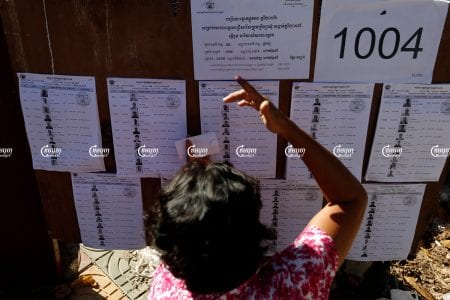 A woman searches for her name on a voting list during commune elections in Phnom Penh. Picture taken on June 4, 2017. CamboJA/ Pring Samrang