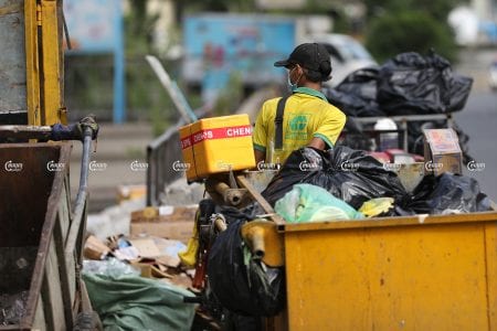 Cintri workers collect garbage along a street in the Chamkar Mon district of Phnom Penh, July 8, 2021. CamboJA/ Pring Samrang