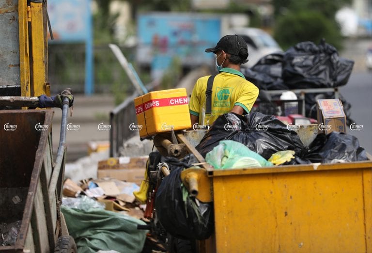 Cintri workers collect garbage along a street in the Chamkar Mon district of Phnom Penh, July 8, 2021. CamboJA/ Pring Samrang