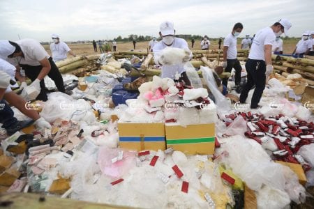 Officials prepare confiscated drugs for burning during a ceremony to mark the International Day against Drug Abuse and Illicit Trafficking in Phnom Penh, July 19, 2021. CamboJA/ Pring Samrang