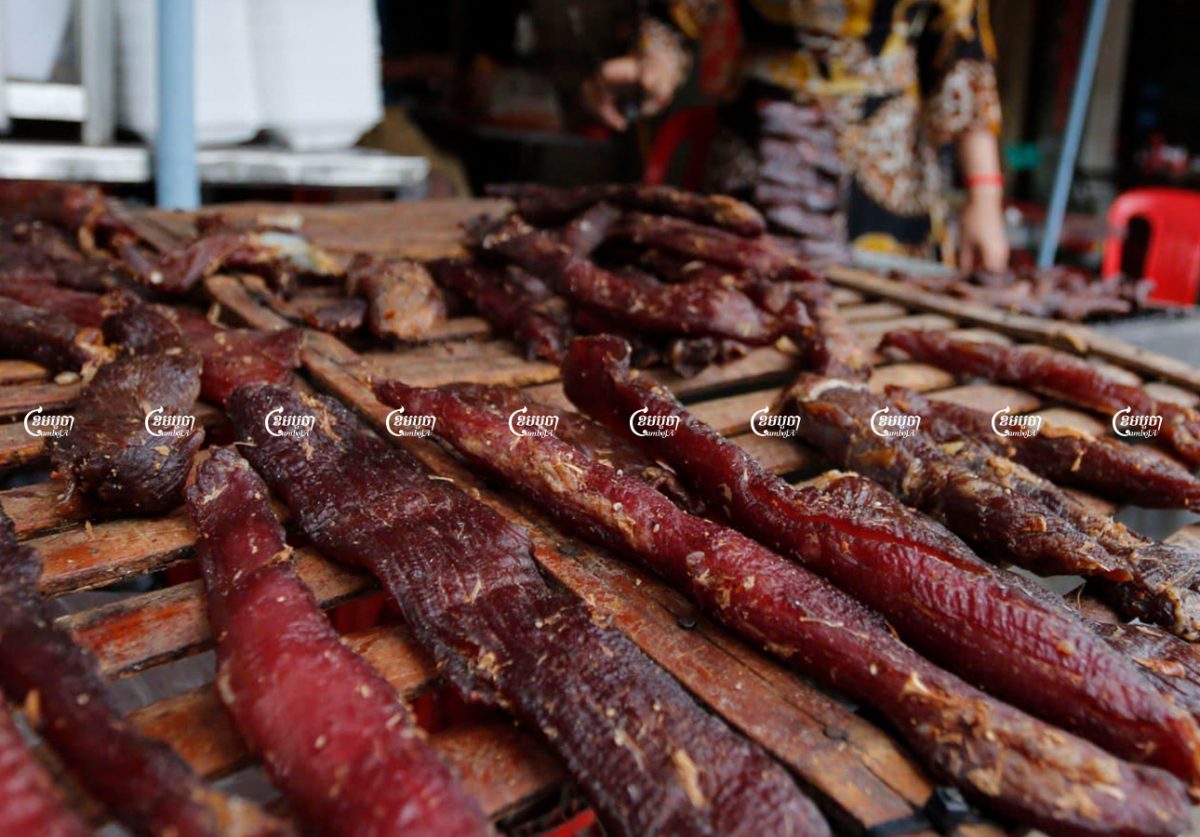 Strips of buffalo meat dry in front of a restaurant along a street in Phnom Penh, July 27. CamboJA/ Panha Chhorpoan