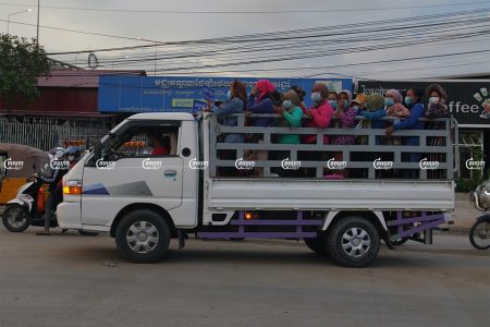 Garment workers travel by truck to factories in Phnom Penh. CamboJA/ Panha Chhorpoan