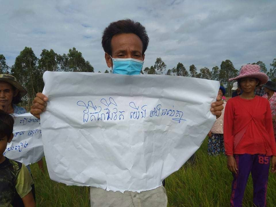 Villagers protesting on their farmland on Monday. The disputed land is within the boundary of a canal restoration project. Supplied