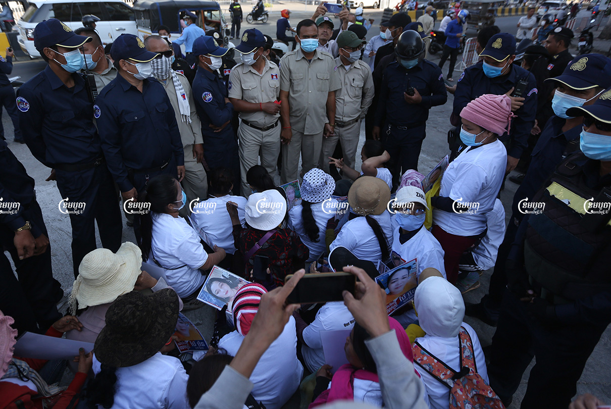 Relatives of imprisoned CNRP members are surrounded by authorities during a protest near the Municipal Court of Phnom Penh, Picture taken on February 18, 2021. CamboJA/ Pring Samrang