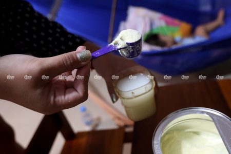 A nanny prepares milk formula for a child in Phnom Penh, September 8, 2021. CamboJA/ Pring Samrang