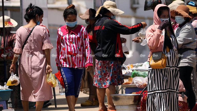 Garment workers buy lunch in front of a factory in Kandal province, picture taken on June 4, 2021. CamboJA/ Pring Samrang