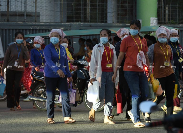 Garment workers leave a factory after finishing their work in Phnom Penh, September 21, 2021. CamboJA/ Panha Chhorpoan