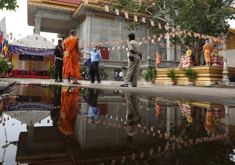 Health officers and authorities speak with a monk at a pagoda to discuss rapid COVID-19 testing, on the third day of Pchum Ben in Phnom Penh, September 24, 2021. CamboJA/ Pring Samrang