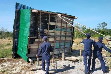 Local authorities and environmental officials destroy the house of a villager accused of building illegally in Botum Sakor National Park in Koh Kong province. The demolition took place on September 3. Photo Supplied