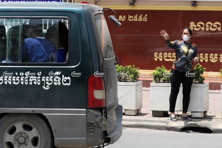 Kak Sovann Chhay's mother Prum Chantha waves to her son in the prisoner's van in front of the Municipal Court of Phnom Penh after his hearing, September 29, 2021. CamboJA/ Pring Samrang