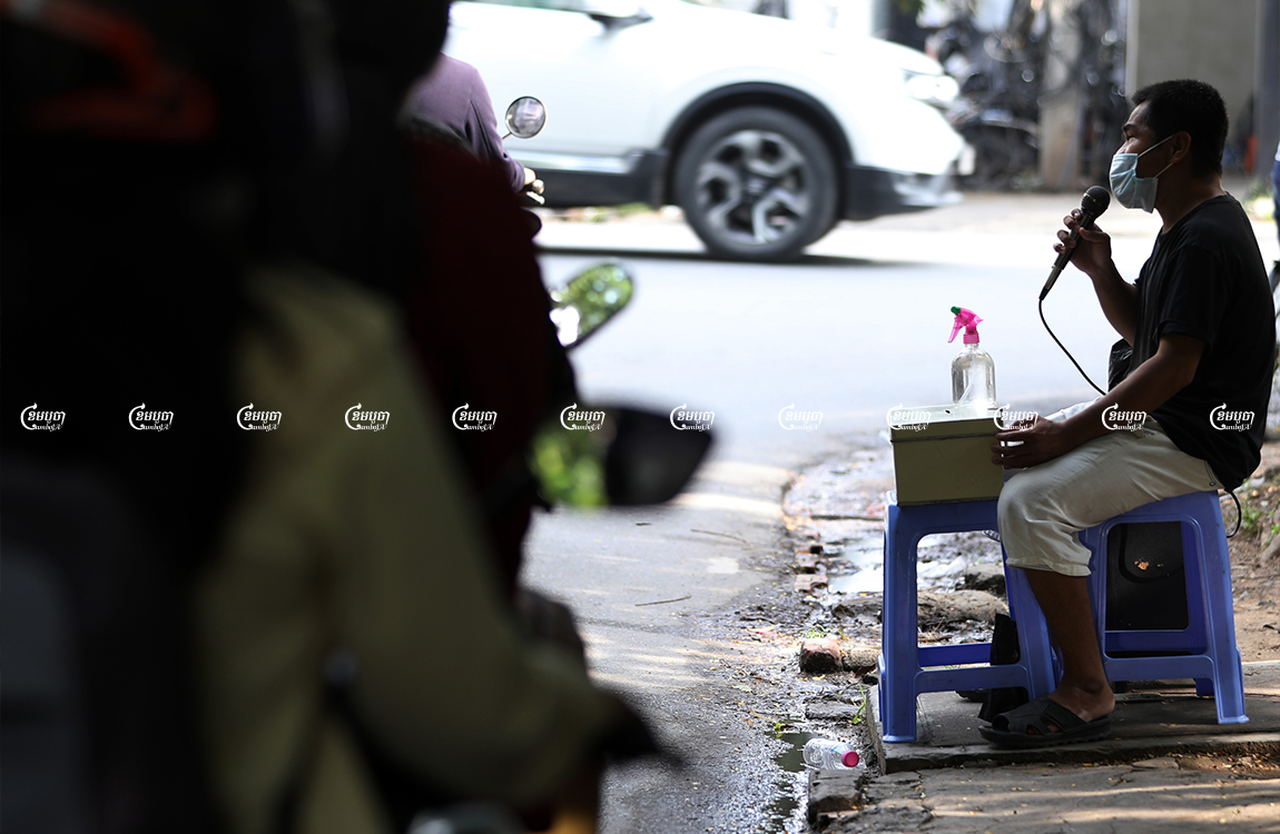 A blind man sings on a street for money in Phnom Penh, Picture taken September 21, 2021. CamboJA/ Pring Samrang