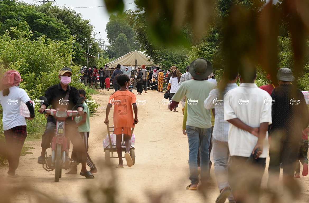 Villagers gather to demonstrate in front of police barricades where authorities blocked a road leading to their farmland, which is being cleared to prepare the site for a planned airport in Kandal Stung district, Picture taken on September 12, 2021. CamboJA/ Panha Chhorpoan