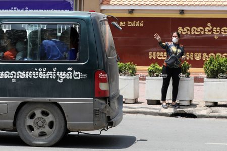 Kak Sovann Chhay's mother Prum Chantha waves to her son as he is taken away in a prison van in front of the Municipal Court of Phnom Penh after his hearing, September 29, 2021. CamboJA/ Pring Samrang
