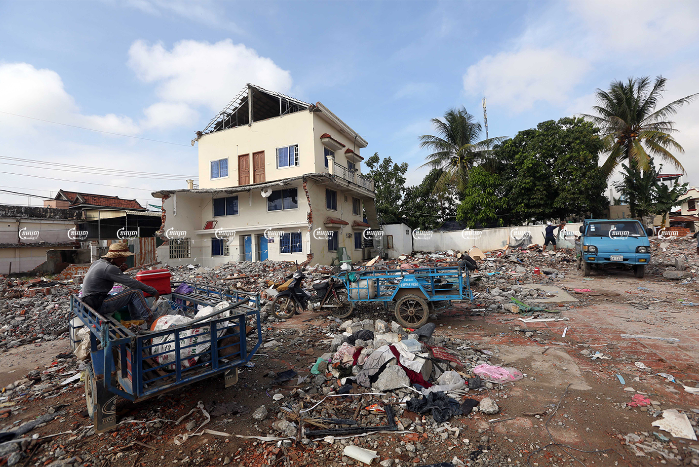 Workers collect scrap from a demolished house in the Pur Senhey district of Phnom Penh, November 2, 2021. CamboJA/ Pring Samrang