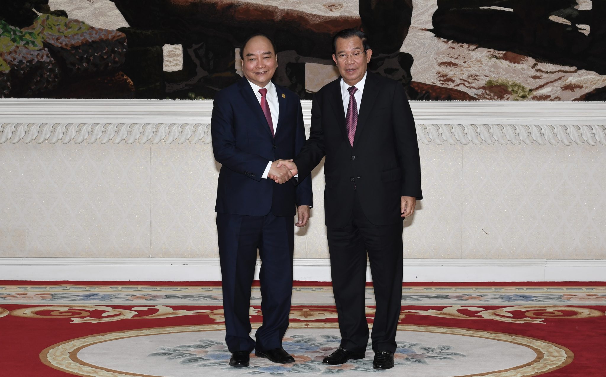 Prime Minister Hun Sen shakes hands with Vietnam President Nguyen Xuan Phuc before a meeting at the Peace Palace in Phnom Penh, December 21, 2021. CamboJA/ Hand Out photo from An Khuon SamAun National Television of Cambodia