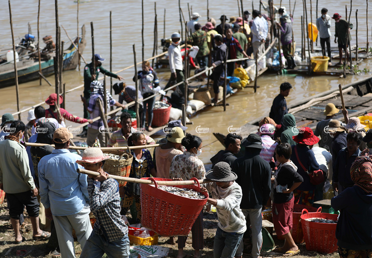 Customers buy fish to make Prahok in Kandal province, December 14, 2021. CamboJA/ Pring Samrang
