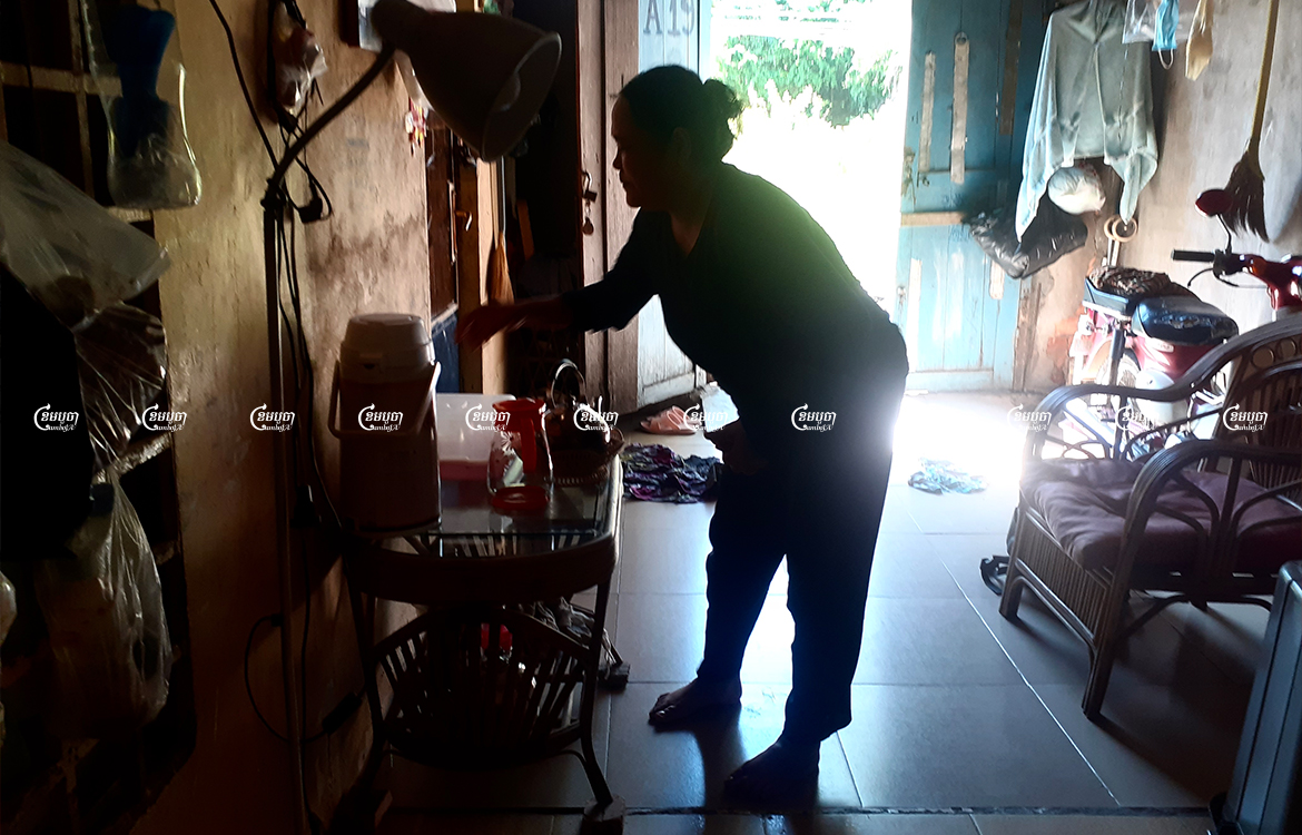 Muong Samnang cleans her home in the Chamkarmon district of Phnom Penh, December 8, 2021. CamboJA/ Chea Sokny