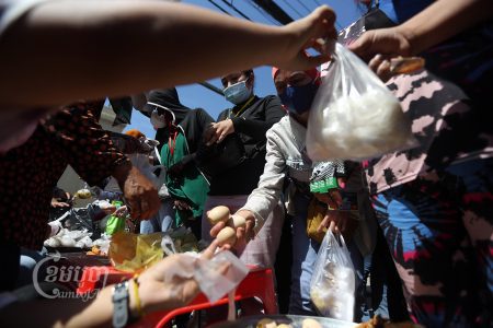 Garment workers converging for their lunch in front of a factory on the outskirts of Phnom Penh, January 14, 2022. CamboJA/ Pring Samrang