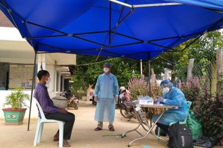 Health officials interview returned Cambodian migrant workers in August 2021. Supplied