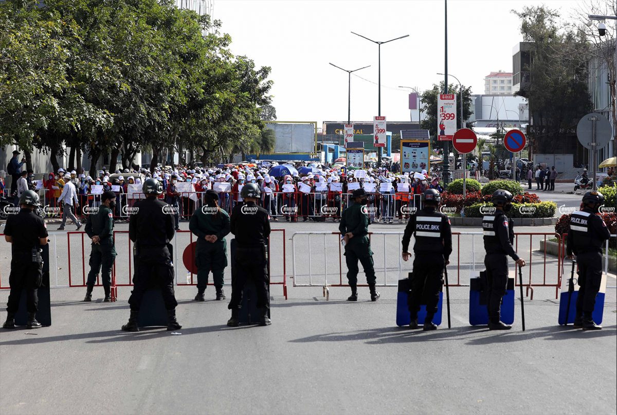 NagaWorld employees continued their strike Monday as police officers blocked their progress outside the Australia embassy in Phnom Penh. Police on Monday also arrested 15 more workers, January 3, 2022. CamboJA/ Pring Samrang
