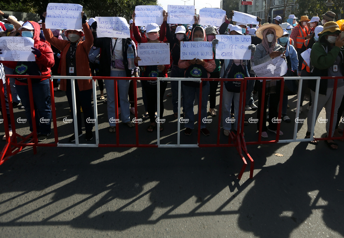 NagaWorld employees continued their strike Monday as police officers blocked their progress outside the Australia embassy in Phnom Penh. Police on Monday also arrested 15 more workers, January 3, 2022. CamboJA/ Pring Samrang