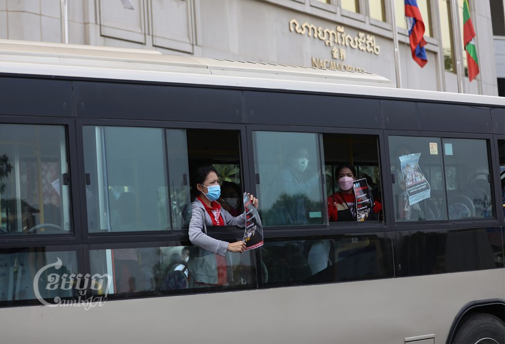 NagaWorld union employees shout for help as authorities force them into a city bus. Police and other officials detained the unionists as they tried to resume their strike in front of the NagaWorld hotel and casino complex in Phnom Penh, March 16, 2022. CamboJA/ Pring Samrang