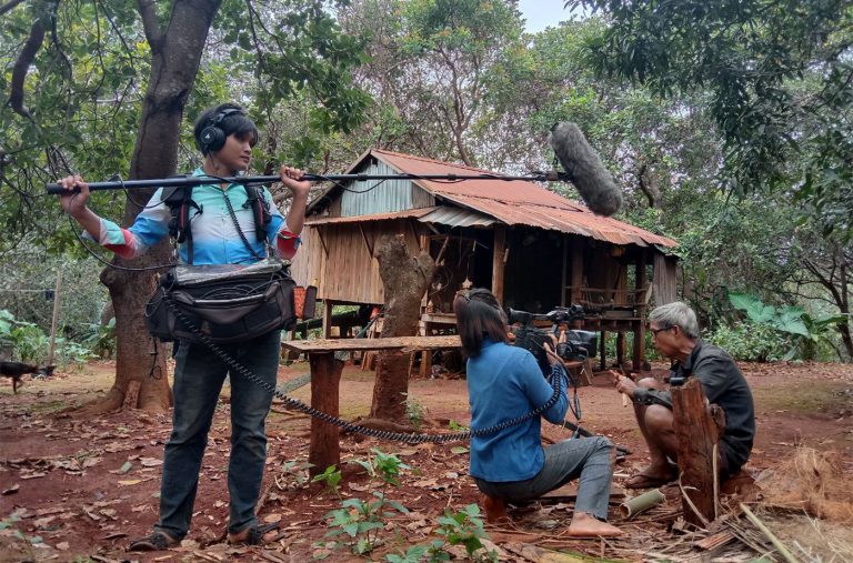 Chen Socheata and her crew film a Tro Khlouk maker as he cuts bamboo to form the instrument in Ratanakiri province on October 24, 2021. Photo supplied