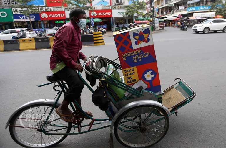 A cyclo driver pedals through his territory as part of the mobile pantry initiative in Phnom Penh, Picture taken August 30, 2021. CamboJA/ Pring Samrang