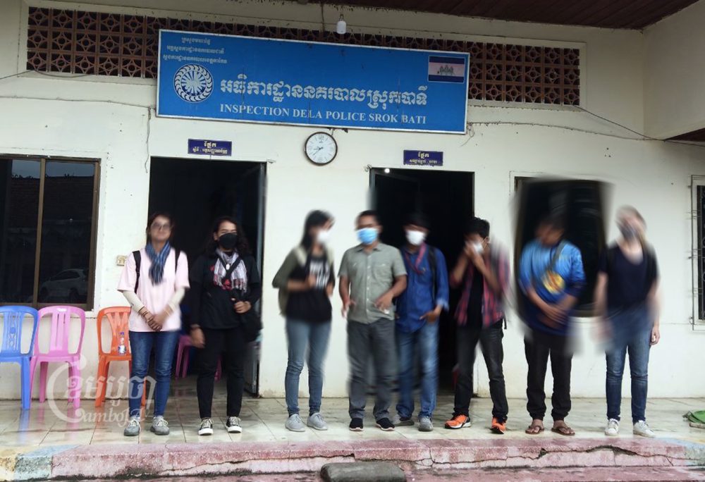 Journalists and environmental activists stand in front of Bati district police station after questioning by police, August 16, 2022. CamboJA/ Bun Rithy