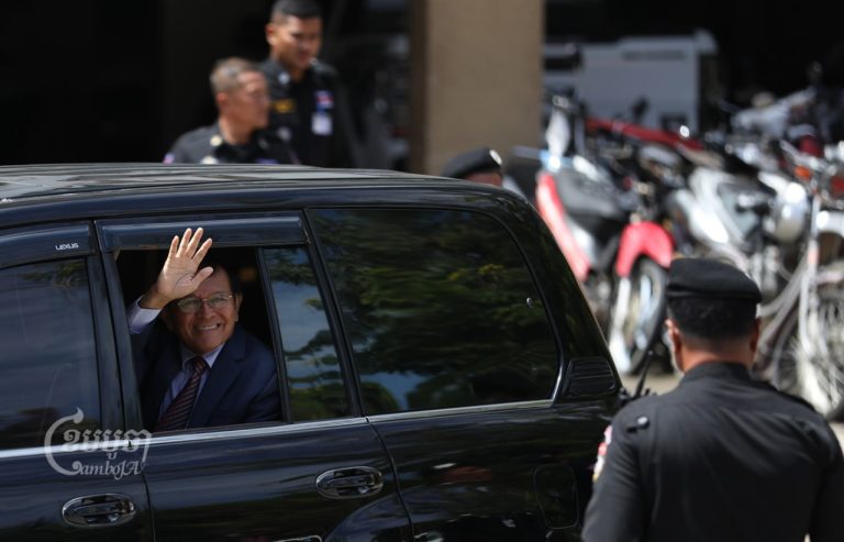 Kem Sokha waves from his vehicle as he leaves the Phnom Penh Municipal Court on October 12, 2022. (CamboJA/Pring Samrang)