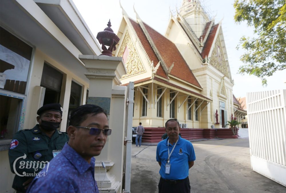 Yi Soksan, a senior investigator at human rights group Adhoc (right), stands outside the Supreme Court in Phnom Penh on November 18, 2022. CamboJA/Pring Samrang