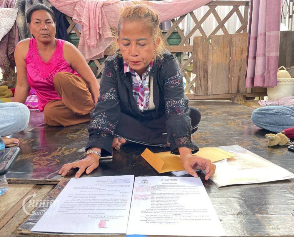 Prak Sophea shows the court summons she got from the court​ and​ her request for delay on February 25, 2023. (CamboJA/Phon Sotthyroth)